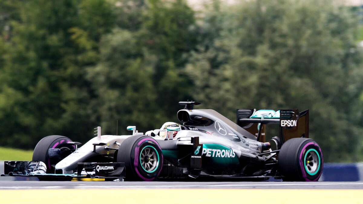 Formula One driver Lewis Hamilton guides his car up a rise during the Austrian Grand Prix on Sunday.