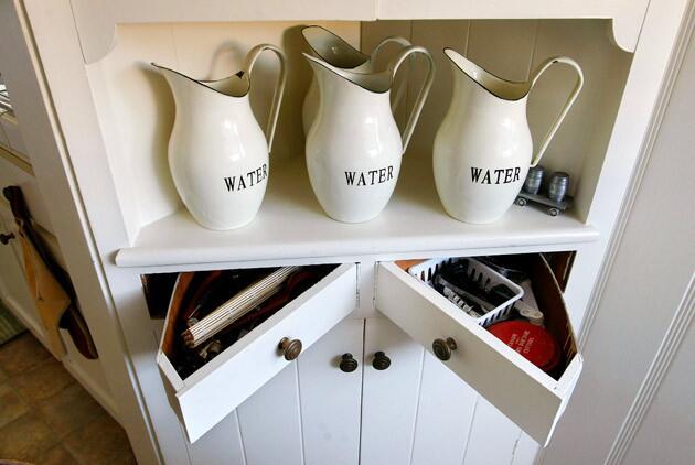 A corner hutch has two ingenious triangular drawers that open toward each other.