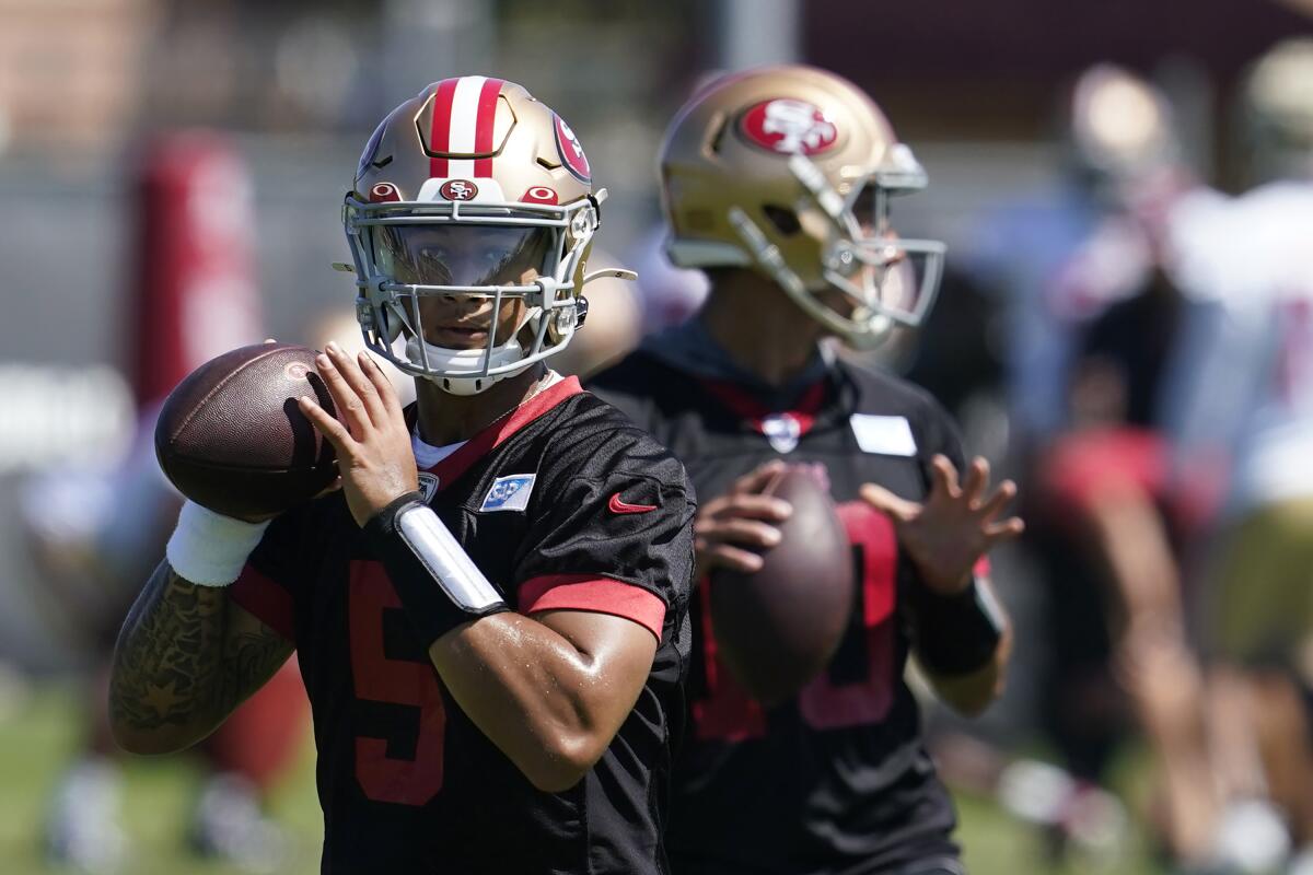 FILE - San Francisco 49ers quarterbacks Trey Lance, left, and Jimmy Garoppolo take part in drills at the NFL football team's practice facility in Santa Clara, Calif., Thursday, Sept. 1, 2022. Lance is ready for his first full season as starting quarterback for the San Francisco 49ers despite getting almost no game action the past two seasons and with former starter Jimmy Garoppolo back on the bench behind him.(AP Photo/Jeff Chiu, File)