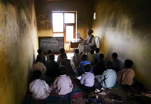 Soot clings to the ceiling and walls of a classroom at a village school in Ghazni province that was targeted by a Taliban bomb.