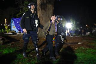 An activist is removed by authorities from a park