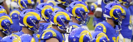 Los Angeles Rams players warm up before an NFL football game against the Arizona Cardinals in Inglewood.