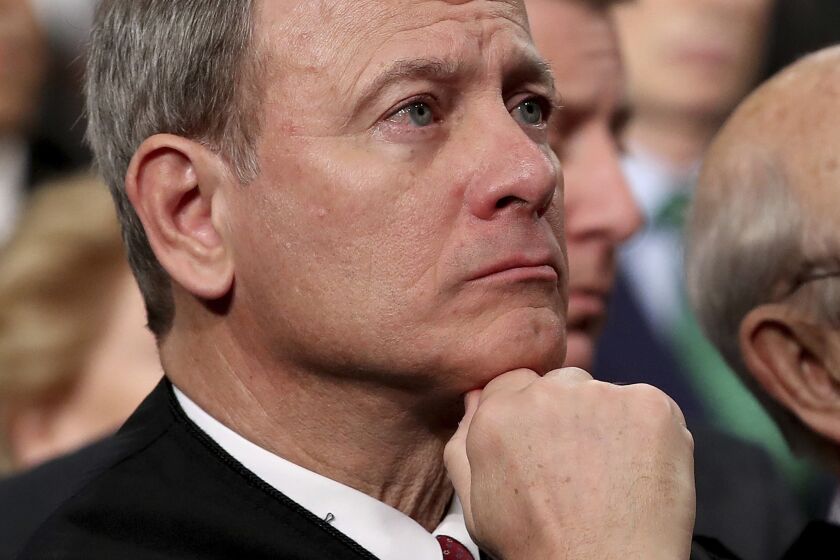 FILE - In this Tuesday, Jan. 30, 2018 file photo, U.S. Supreme Court Chief Justice John Roberts listens as President Donald Trump delivers his first State of the Union address in the House chamber of the U.S. Capitol to a joint session of Congress in Washington. Supreme Court Chief Justice John Roberts is using his annual report on the federal judiciary to highlight the steps the branch has taken to combat inappropriate conduct in the workplace. (Win McNamee/Pool via AP)