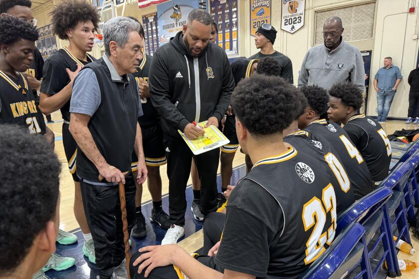 King/Drew coach Lloyd Webster directs his team during a timeout on Tuesday against Marina.