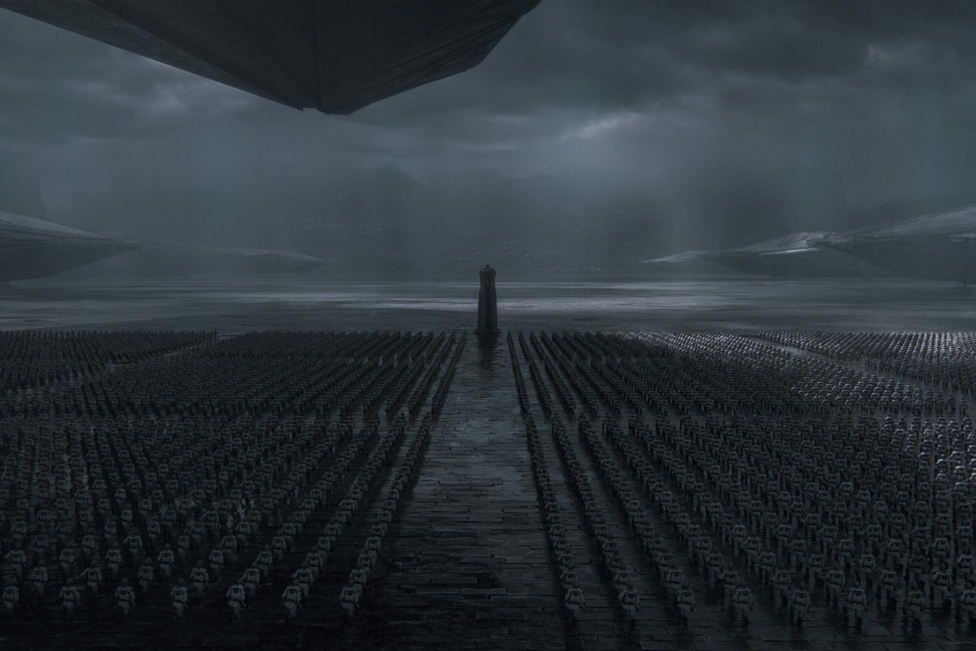 A massive army lines up in columns under gloomy skies in a scene from Dune