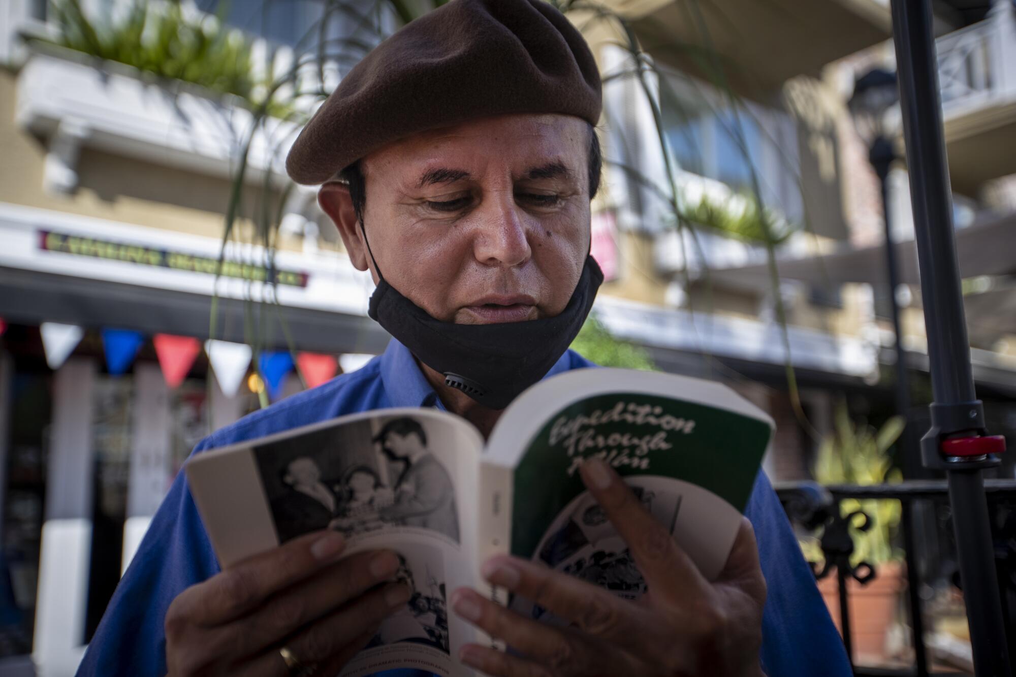 David Sanchez flips through his book, "Expedition Through Aztlán."