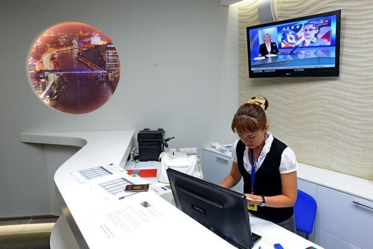An employee works at the reception desk at the Capsule Hotel Air Express at Moscow's Sheremetyevo airport, where Edward Snowden is said to have landed Sunday.