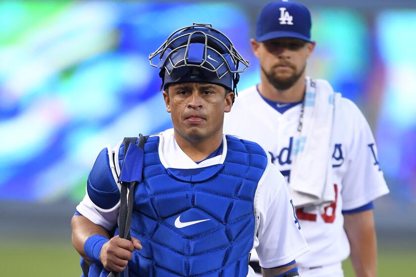 Newly acquired catcher Carlos Ruiz heads to the Dodgers' dugout before a game against the Cubs on Friday.