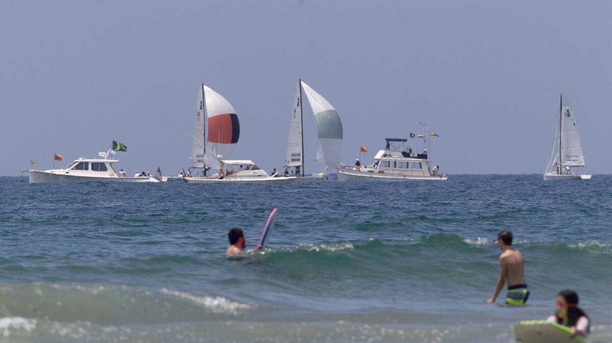 Boats sail along the coast, north of Newport Pier, during opening day for Balboa Yacht Club's Governor's Cup.
