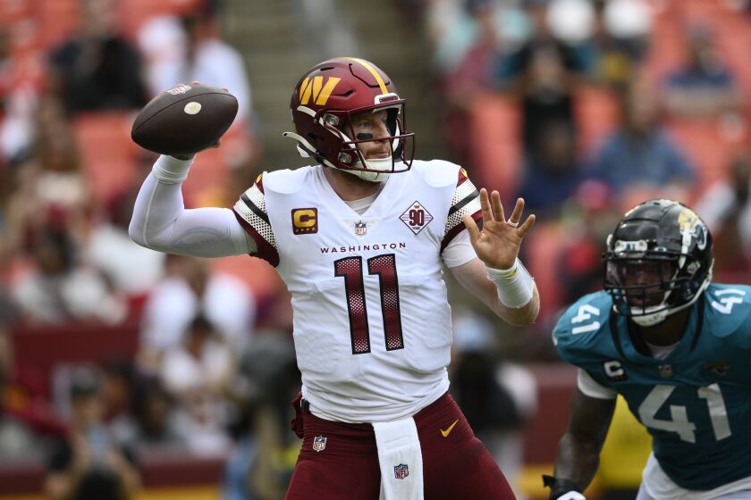 Washington Commanders quarterback Carson Wentz (11) in action during the second half of a NFL football game against the Jacksonville Jaguars, Sunday, Sept. 11, 2022, in Landover, Md. (AP Photo/Nick Wass)
