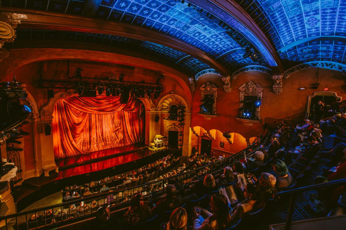 Theatergoers sit inside the Pasadena Playhouse.