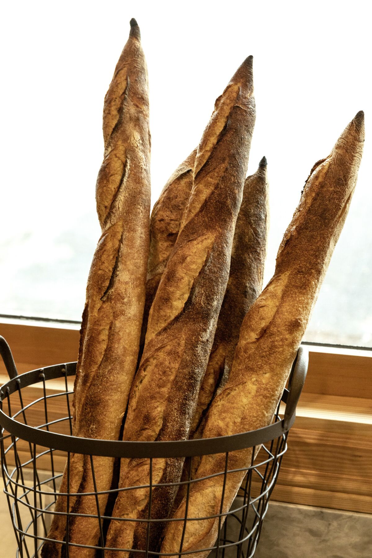 Baguettes in a basket on the pastry counter at Fiona.