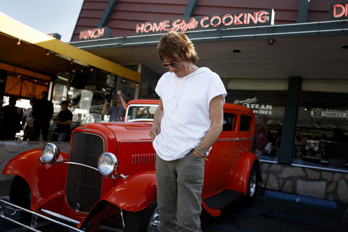 Rock guitarist Jeff Beck drove a restored 1932 Ford to Mel's Drive-In in West Hollywood on Monday to take part in a book release event for the publication of his book "BeckO1," showcasing his dual passions for guitars and vintage cars. (Jay L. Clendenin/Los Angeles Times)