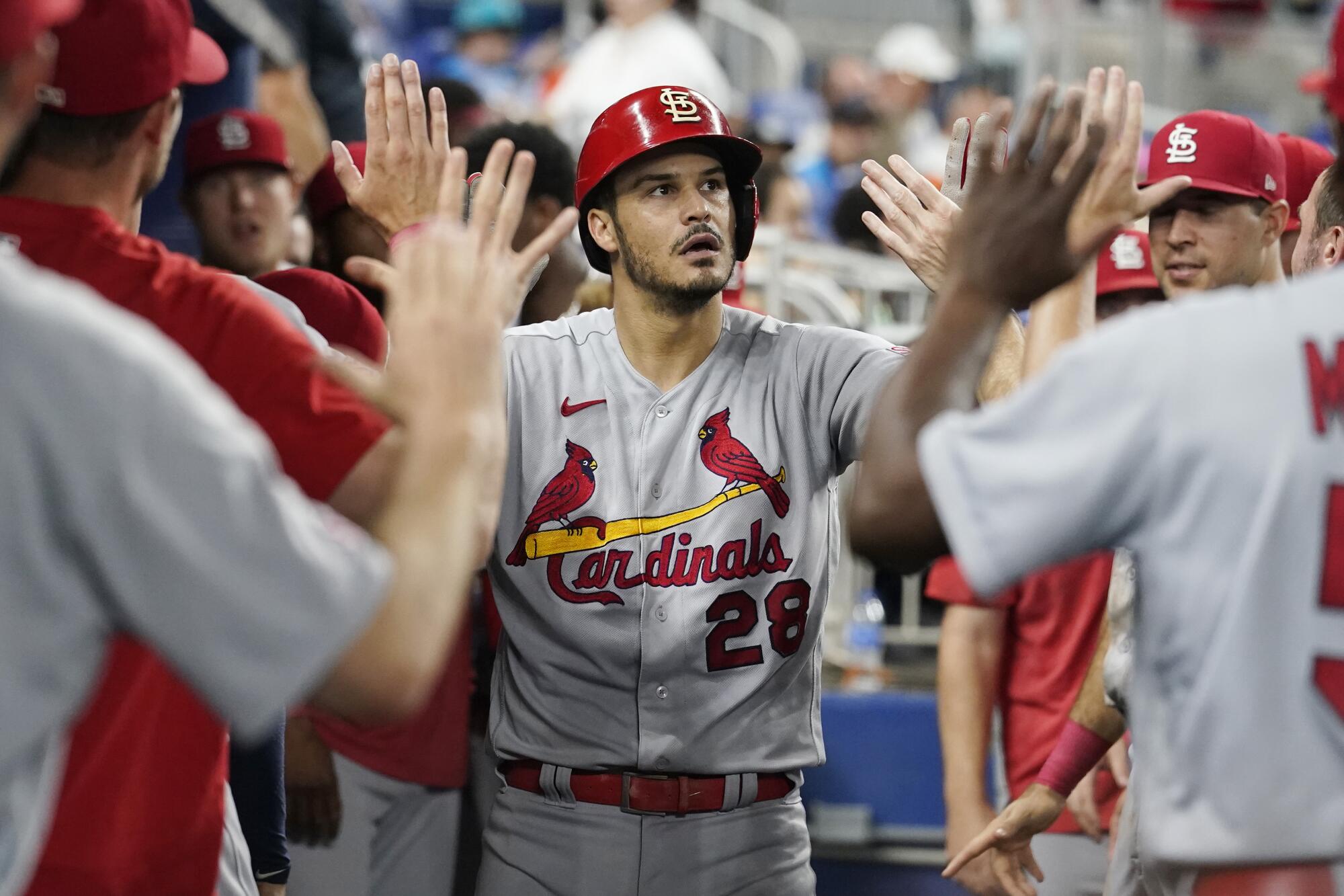 Cardinals third baseman Nolan Arenado is congratulated by his teammates after hitting a solo homer.