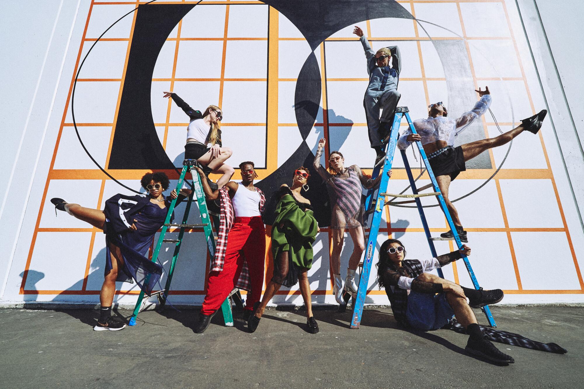 Eight dancers from the L.A. Dance Project pose in front of a mural by Channa Horowitz in the dance studio’s parking lot. 