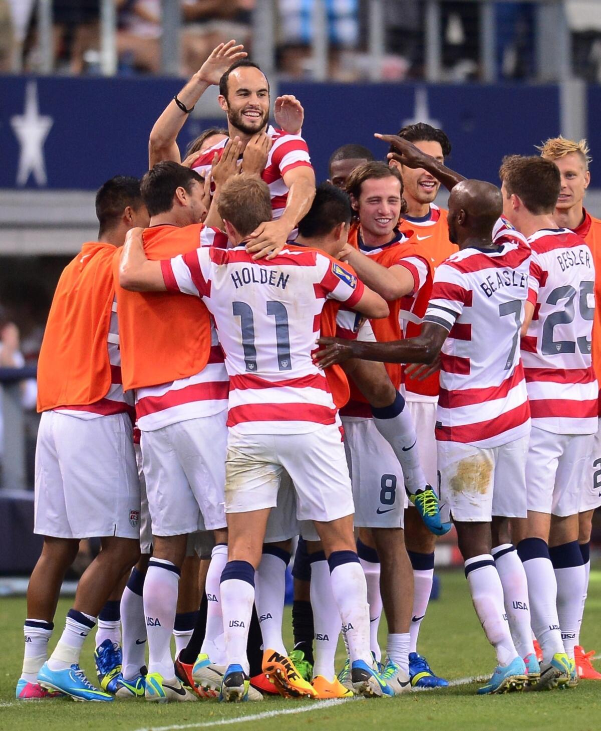 Landon Donovan celebrates with his teammates after scoring the first of his two goals in a U.S. win over Honduras on Wednesday. Could a Gold Cup win over Panama pave the way to greater things at next year's World Cup?