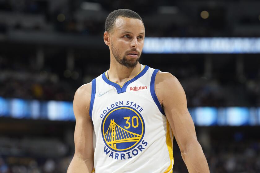 Closeup of a professional basketball player in a jersey that says Golden State Warriors.