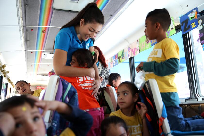 TIJUANA, MEX-NOVEMBER 26, 2019: Estefania Rebellón greets the students in the preschool and elementary classroom that is also a bus run by Yes We Can Mobile Schools, a project of the Yes We Can World Foundation, a nonprofit formed to support migrant children staying on Mexico's northern border while they wait for U.S. authorities to accept or deny their asylum applications on November 26, 2019, in Tijuana, Mexico. The school began operating in July and serves about 45 students. (Photo By Dania Maxwell / Los Angeles Times)