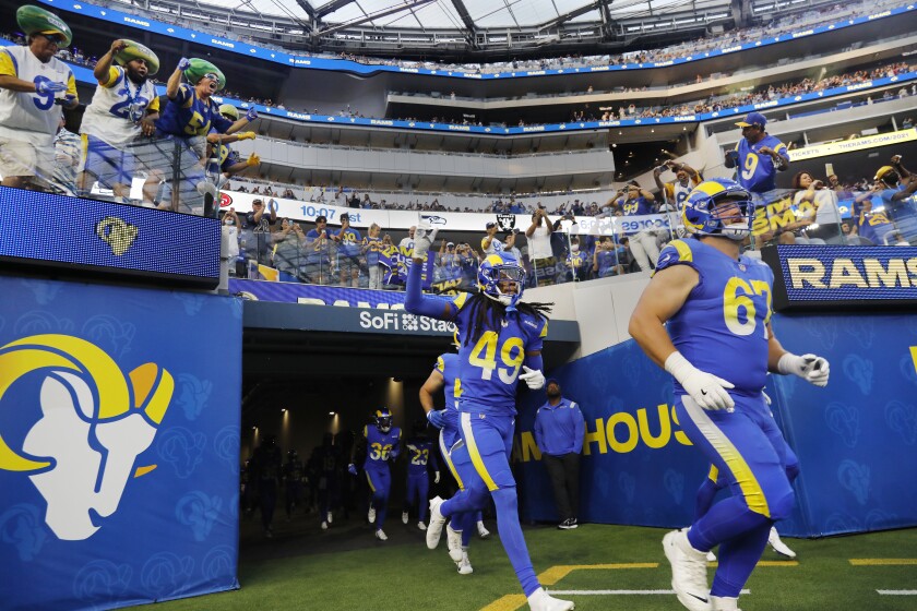 INGLEWOOD, CA - AUGUST 14, 2021: Rams fas cheer as the team enter the stadium for a preseason game against the Chargers on August 14, 2021 in Inglewood, California. (Gina Ferazzi / Los Angeles Times)