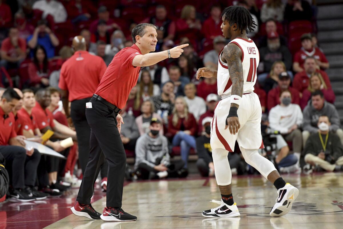 Arkansas coach Eric Musselman talks with Arkansas guard Chris Lykes (11) during a time out against Missouri during the first half of an NCAA college basketball game Wednesday, Jan. 12, 2022, in Fayetteville, Ark. (AP Photo/Michael Woods)