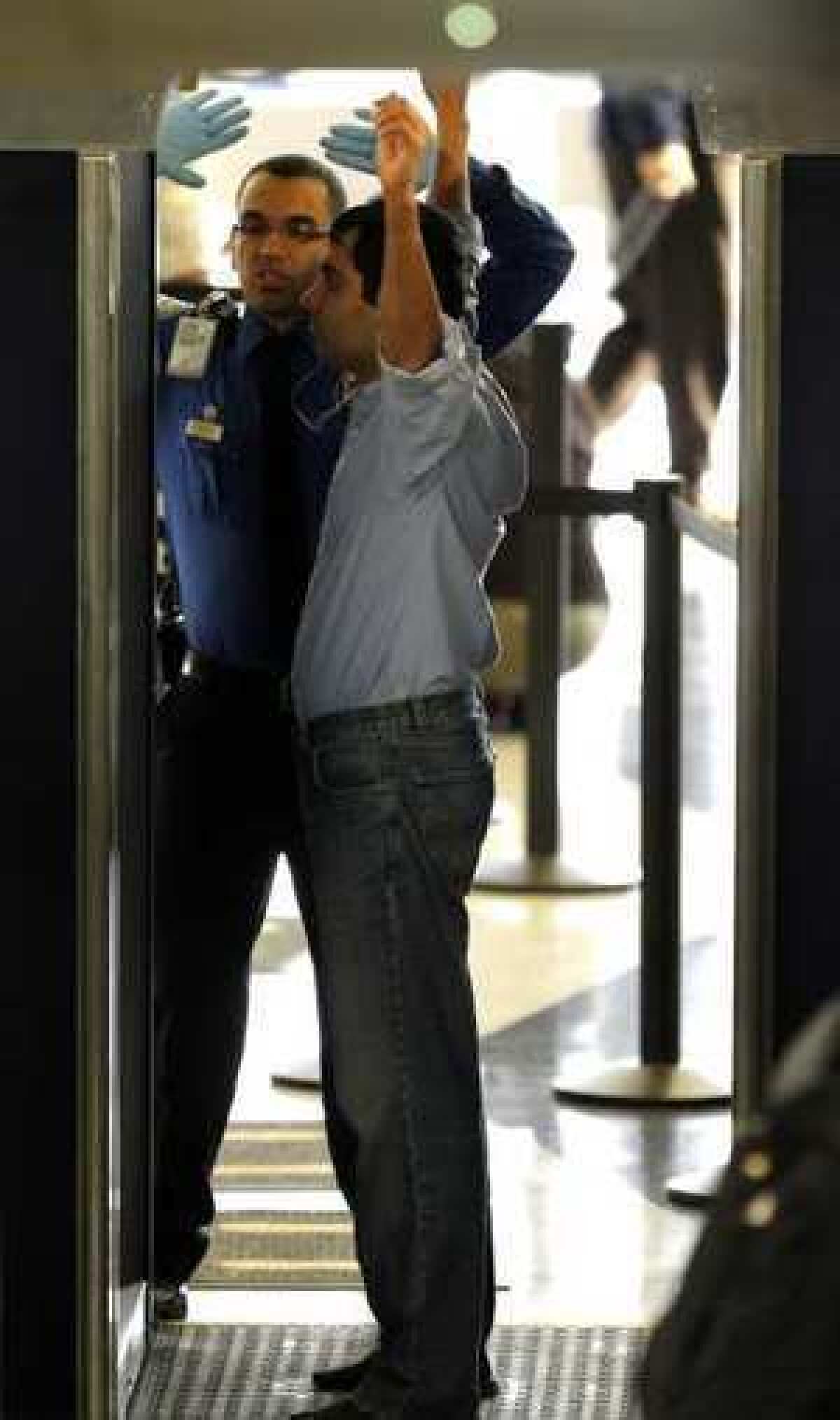 An airline passenger proceeds through a full-body scanner this week at Chicago's O'Hare Airport.