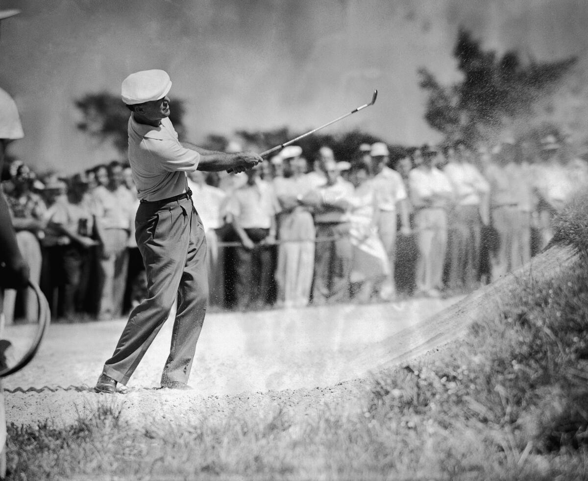 Ben Hogan hits out of a sand trap during the first round of the National Open in Oakmont, Pa., on June 9, 1953.