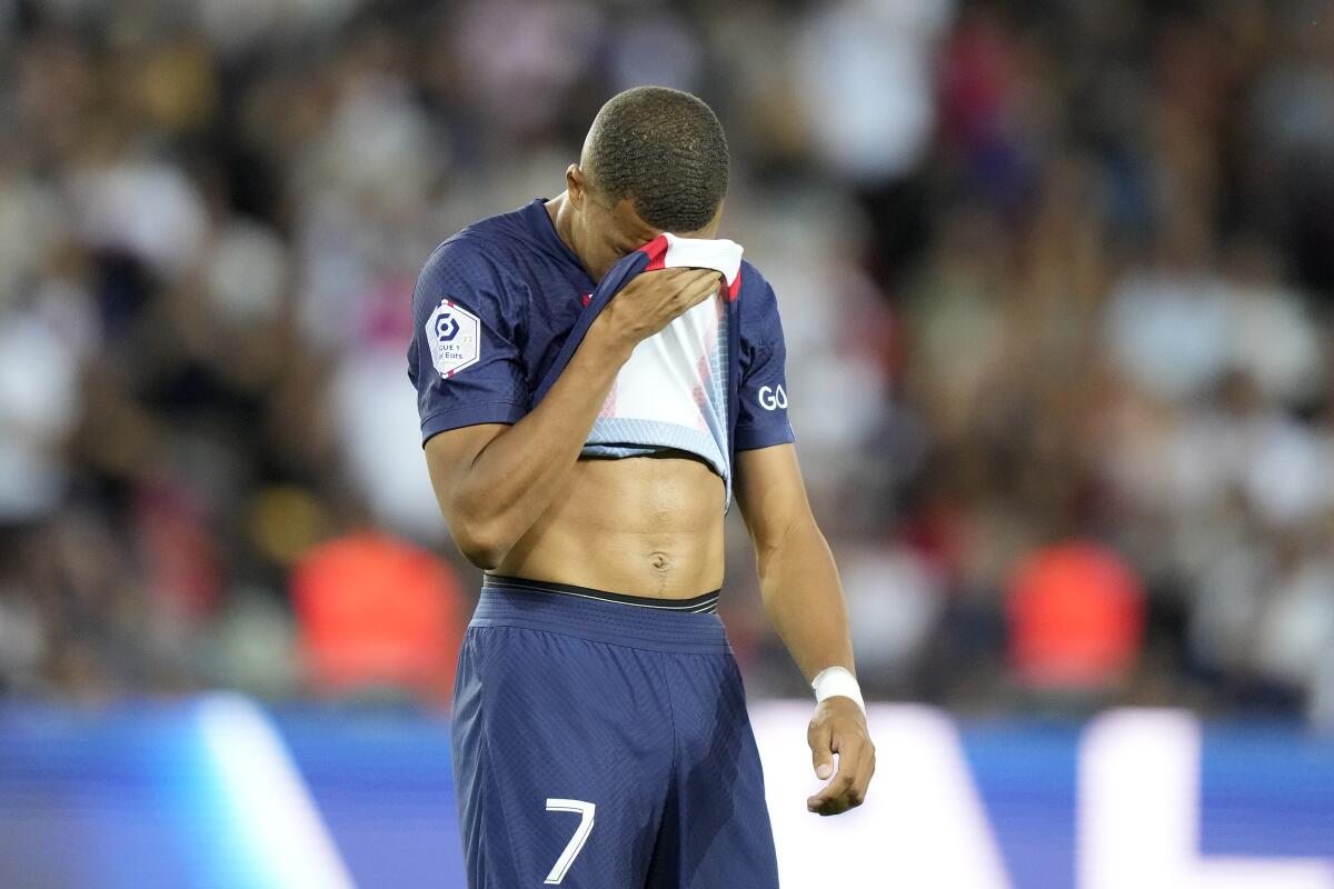 PSG's Kylian Mbappe reacts after missing a penalty during the French League One soccer match between Paris Saint-Germain and Montpellier at the Parc des Princes in Paris, Saturday, Aug. 13, 2022. (AP Photo/Francois Mori)