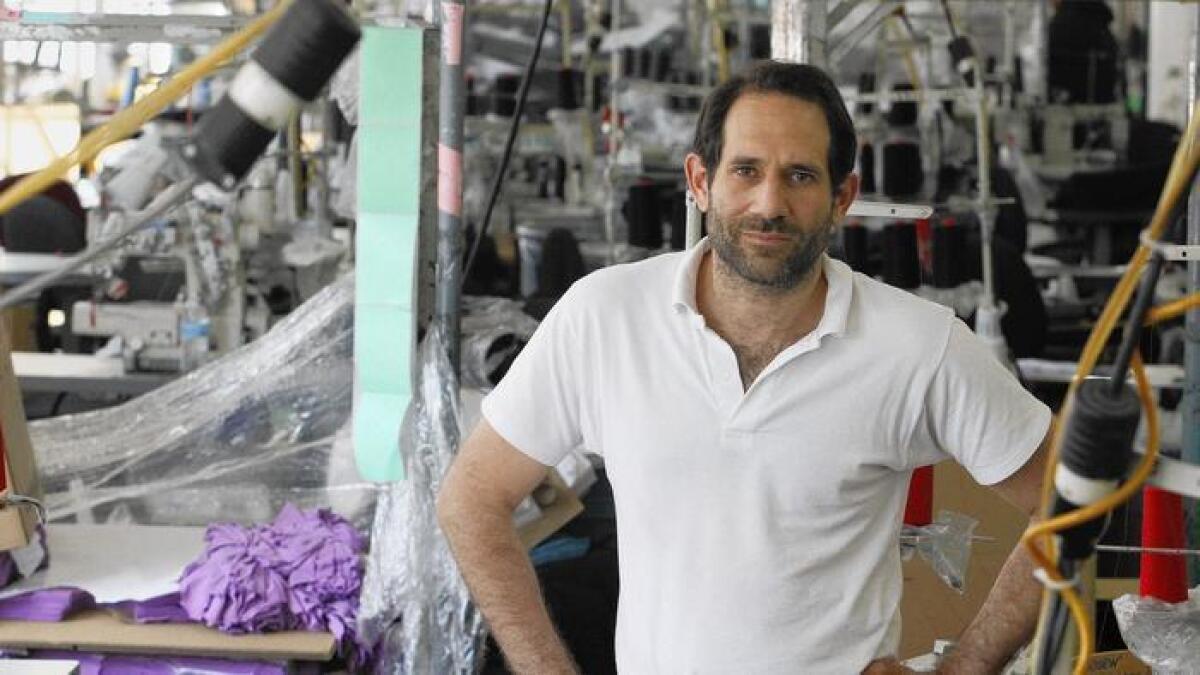 American Apparel is moving to block Dov Charney from upping his stake in the company that ousted him.