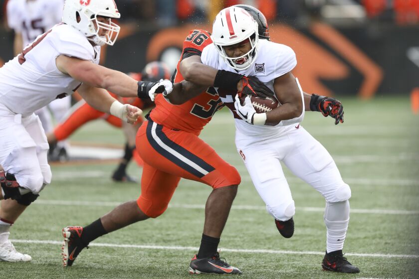 Stanford running back Dorian Maddox, right, slips a tackle from Oregon State inside linebacker Omar Speights (36) during the first half of an NCAA college football game in Corvallis, Ore., Saturday, Sept. 28, 2019. (AP Photo/Amanda Loman)