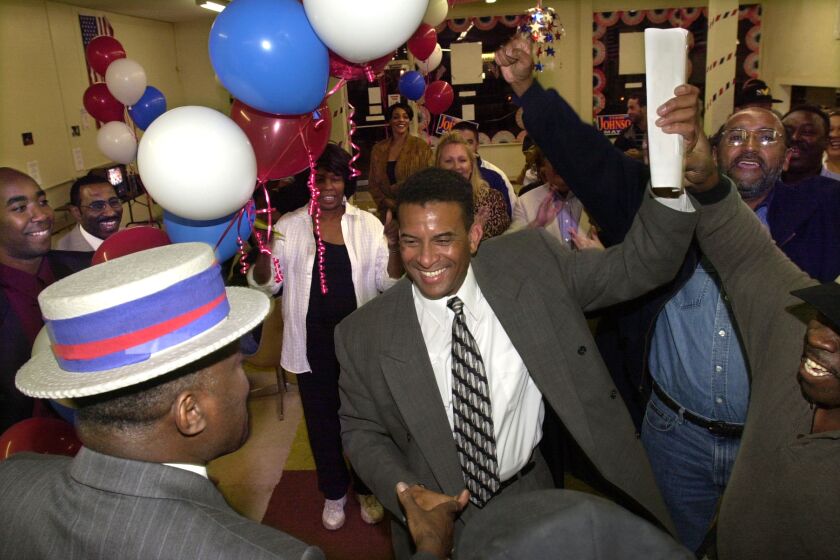 TERRY JOHNSON (middle) celebrates with his supporters at 11:30 p.m. after finding out for sure that he won the Oceanside mayoral election. At lower left in hat shaking his hand is friend and campaign supporter CHUCK CARTER. U/T photo CHARLIE NEUMAN