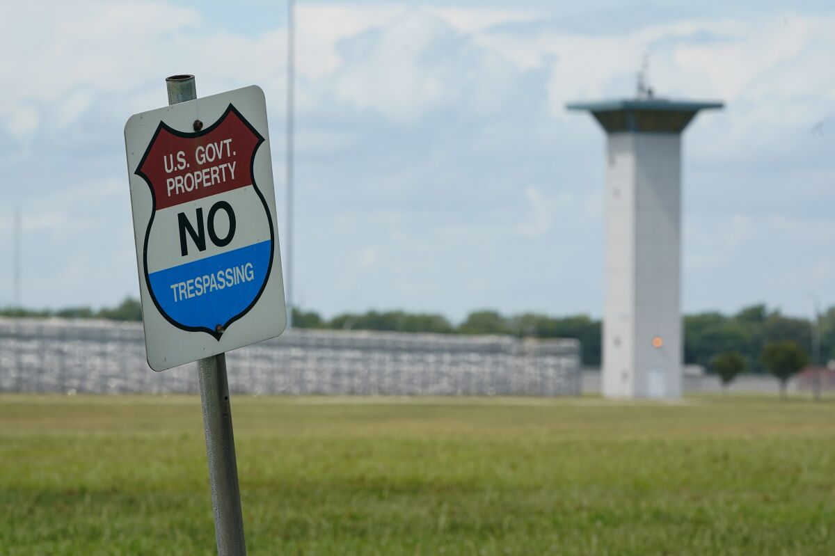 FILE - In this Aug. 28, 2020, file photo, a no trespassing sign is displayed outside the federal prison complex in Terre Haute, Ind. Over the past 18 months, 29 prisoners have escaped from federal lockups across the U.S. - and nearly half still have not been caught. (AP Photo/Michael Conroy, File)