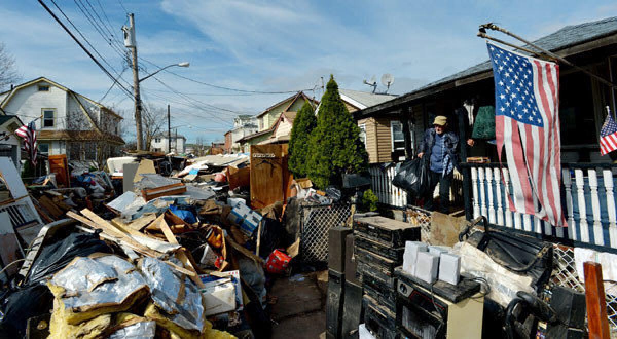 Sal Conte cleans up the damage from the storm surge of Hurricane Sandy in the New Dorp Beach neighborhood of Staten Island, New York.