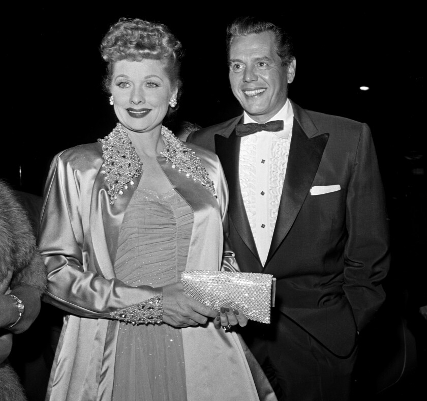 Lucille Ball and her husband, Desi Arnaz, attend a formal event circa 1955.