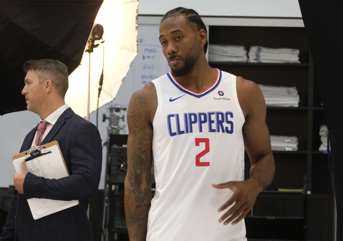 Clippers forward Kawhi Leonard gets ready to pose for photos during media day on Sept. 29, 2019.