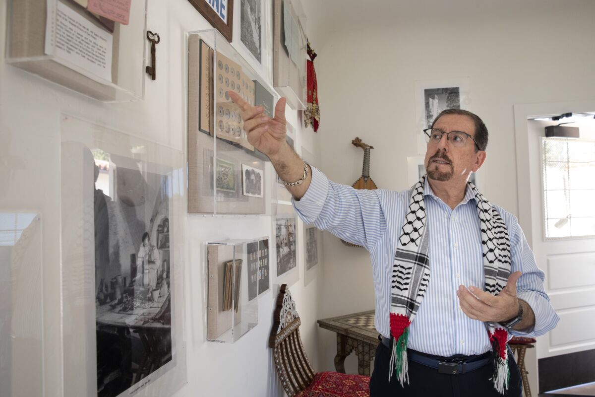 House of Palestine President Yousef Ghandour points to a key that hangs on the wall of the House of Palestine at Balboa Park