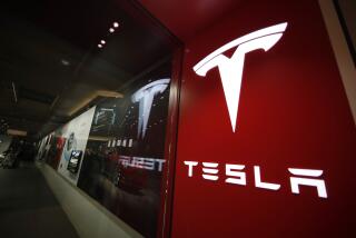 FILE - A sign bearing the Tesla company logo is displayed outside a Tesla store in Cherry Creek Mall in Denver, Colorado, Feb. 9, 2019. U.S. safety regulators are turning up the heat on Tesla, announcing investigations into steering wheels coming off some SUVs and a fatal crash involving a Tesla suspected of using an automated driving system when it ran into a parked firetruck in California. (AP Photo/David Zalubowski, File)
