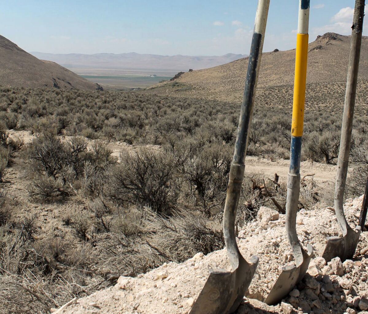FILE - Exploration drilling continues for Permitting Lithium Nevada Corp.'s Thacker Pass Project on the site between Orovada and Kings Valley, in Humboldt county, Nev., shown beyond a driller's shovels in the distance on Sept. 13, 2018. A federal judge on Monday, Feb. 6, 2023, ordered the government to revisit part of its environmental review of a lithium mine planned in Nevada but denied opponents' effort to block the project in a ruling the developer says clears the way for construction at the largest known U.S. lithium deposit. (Suzanne Featherston/The Daily Free Press via AP, File)