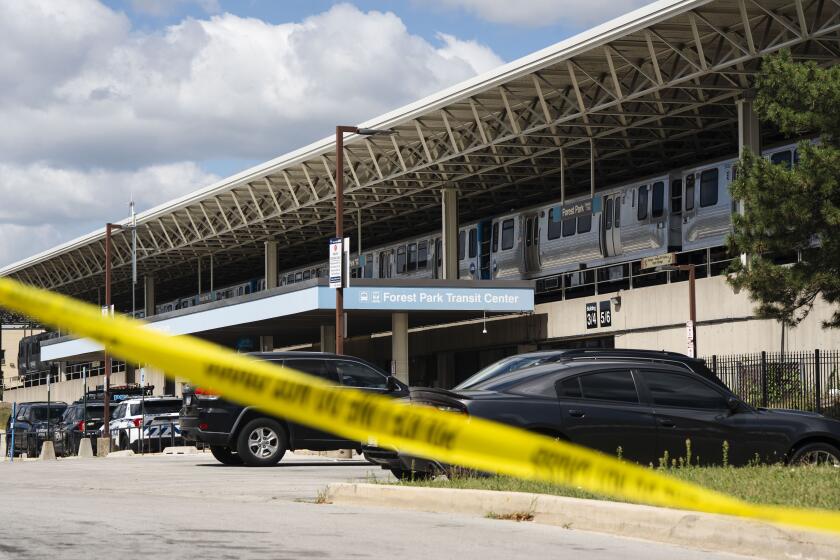 Yellow tape blocks off the parking lot of the Forest Park Blue Line train station in Forest Park, Ill., after four people were fatally shot on the train early Monday, Sept. 2, 2024. (Pat Nabong/Chicago Sun-Times via AP)