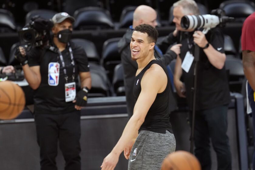 Denver Nuggets forward Michael Porter Jr. jokes with teammates during practice ahead of Game 1 of the NBA basketball finals against the Miami Heat Wednesday, May 31, 2023, in Denver. (AP Photo/David Zalubowski)