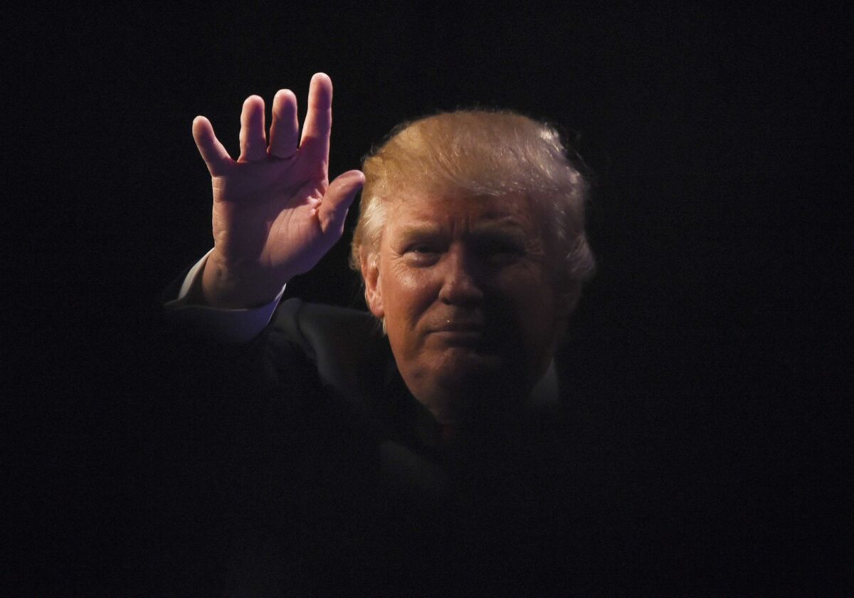 Republican presidential hopeful Donald Trump waves at a rally in Las Vegas on Dec. 14. Trump's recent statements about Muslims are likely to dominate Tuesday's GOP candidate debate.