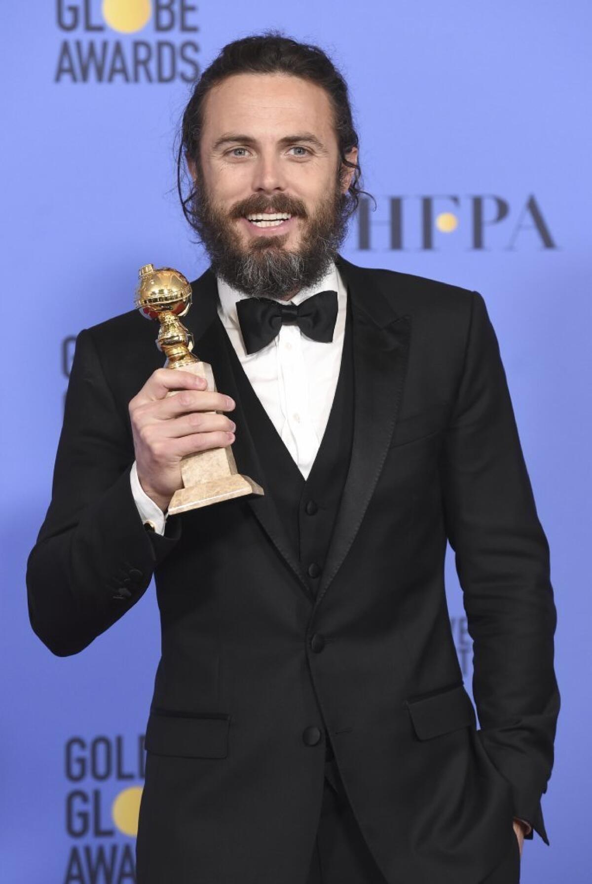 Casey Affleck poses in the press room with the award for best performance by an actor in a motion picture - drama for "Manchester by the Sea" room at the 74th annual Golden Globe Awards at the Beverly Hilton Hotel on Sunday, Jan. 8, 2017, in Beverly Hills, Calif.