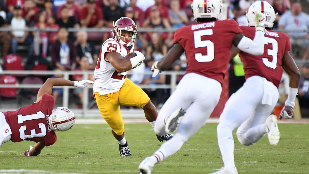 USC runing back Vavae Malepeai turns upfield against the Stanford defense.