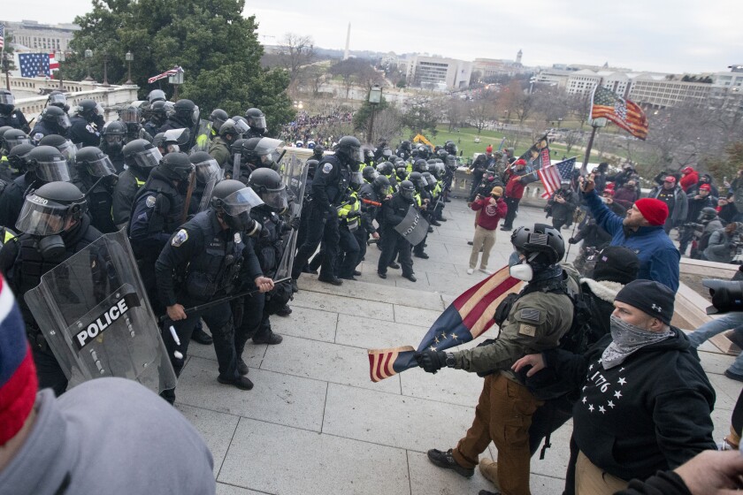 Rioters face off with police at the U.S. Capitol on Jan. 6, 2021, in Washington. A pro-Trump social media influencer who posted video of himself at the U.S. Capitol during last year’s riot has been sentenced to three months of home detention.(AP Photo/Jose Luis Magana)
