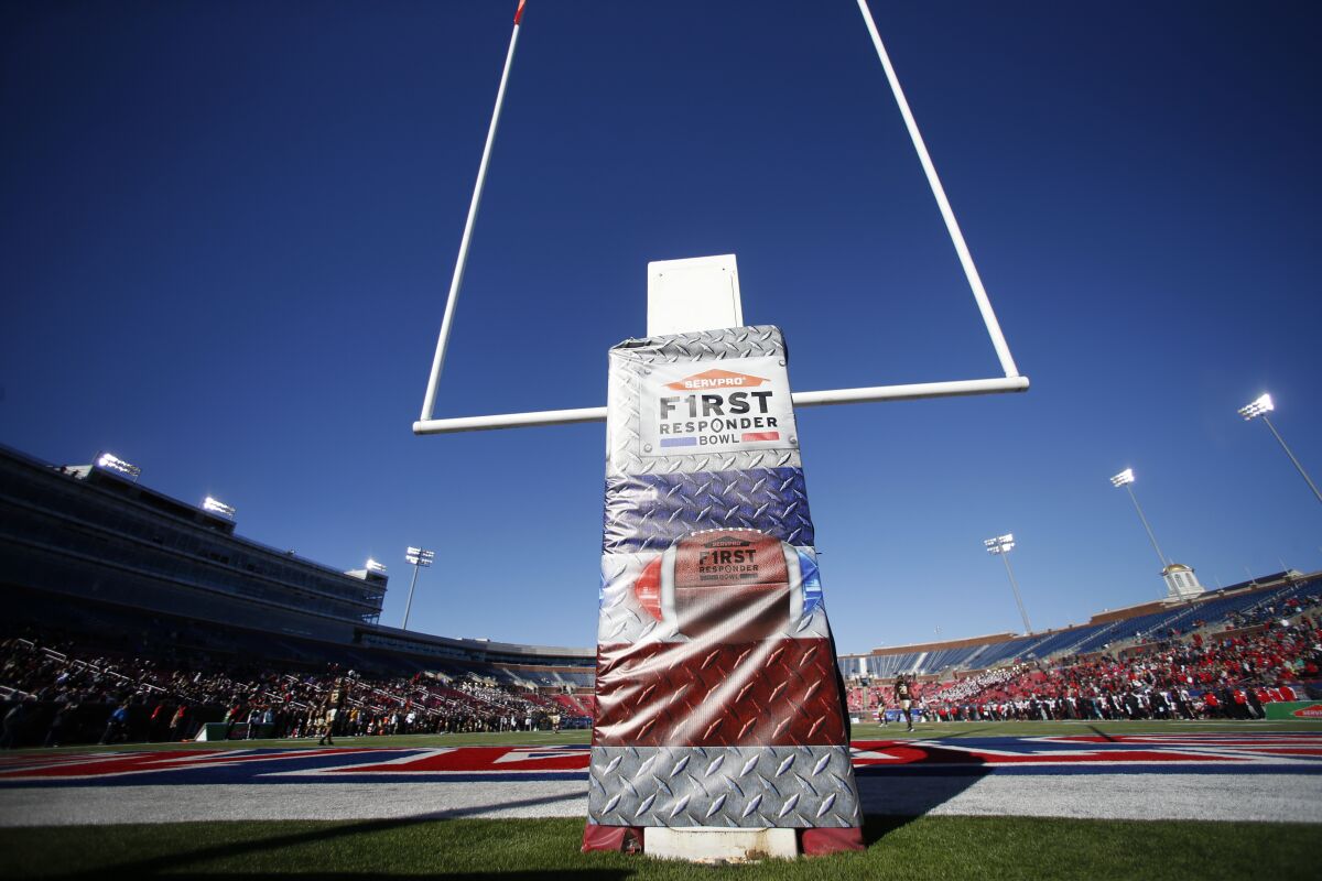 FILE - The First Responder Bowl logo is displayed on the goalpost during the NCAA college football game between Western Kentucky and Western Michigan in Dallas, on Dec. 30, 2019. A study by The Institute for Diversity and Ethics in Sport (TIDES) at Central Florida reported that the overall Graduation Success Rate (GSR) for bowl-bound teams had increased to 81.3%, up from 78% for 2020. Yet the racial gap fell as the average GSR for Black athletes rose from 73.4% in 2020 to 78% this year while white athletes remained steady at 89.7%. (AP Photo/Roger Steinman, File)