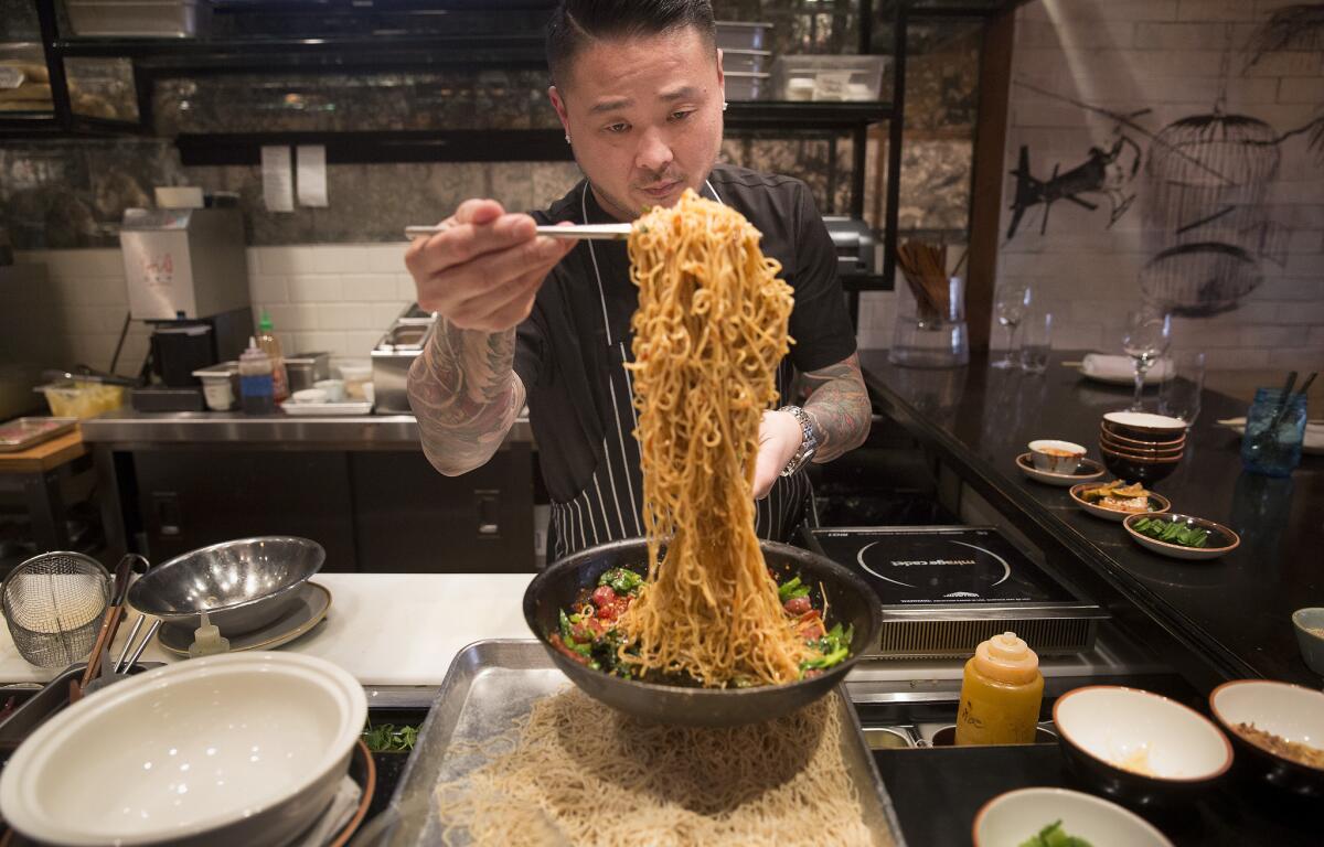 Chef Tin Vuong prepares long life noodles, a Chinese New Year staple.