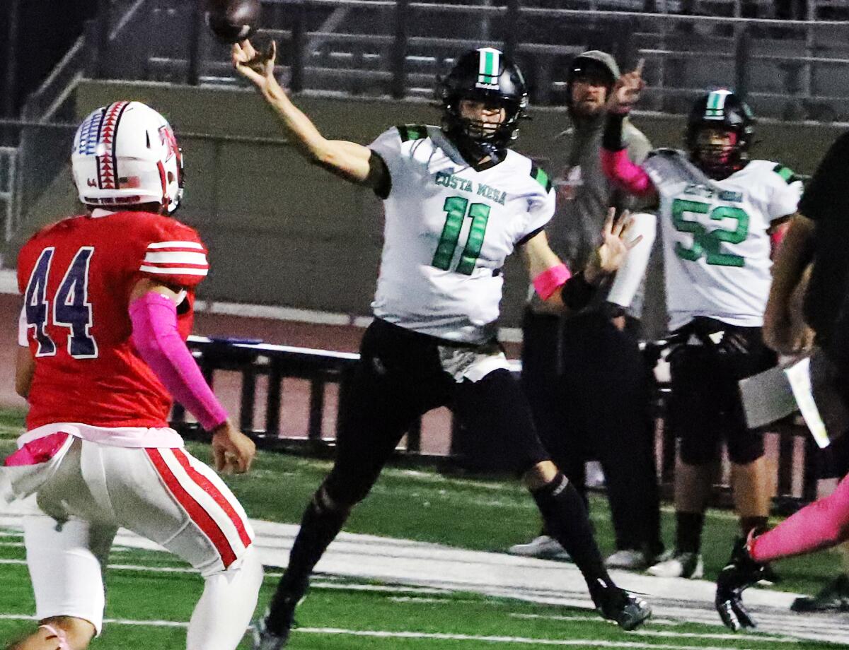 Costa Mesa's quarterback Andrew Waiss (11) passes against Bolsa Grande High School boys' football team.