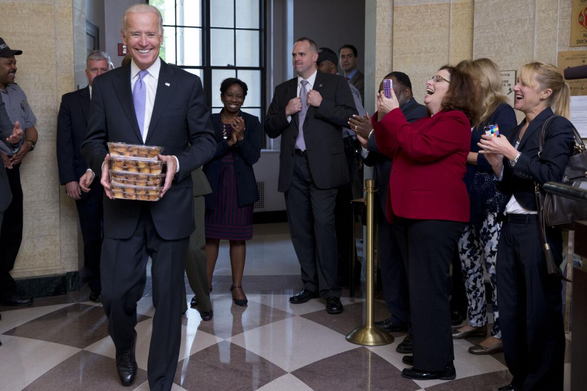 Vice President Joe Biden greets Environmental Protection Agency workers with muffins as they return to work.