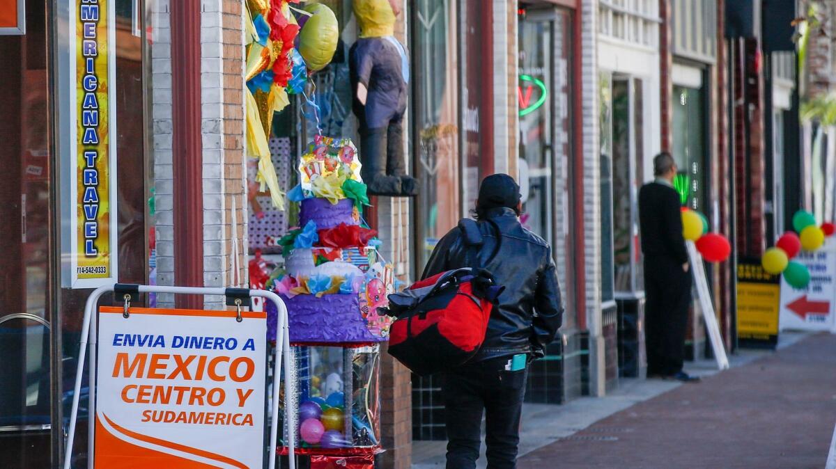 Life goes on along Fourth Street in Santa Ana as details of President Trump's deportation plans emerge and anxiety and anger surface among some residents surface.