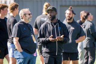 UCLA head coach Deshaun Foster talks on the sidelines during UCLA's pro day