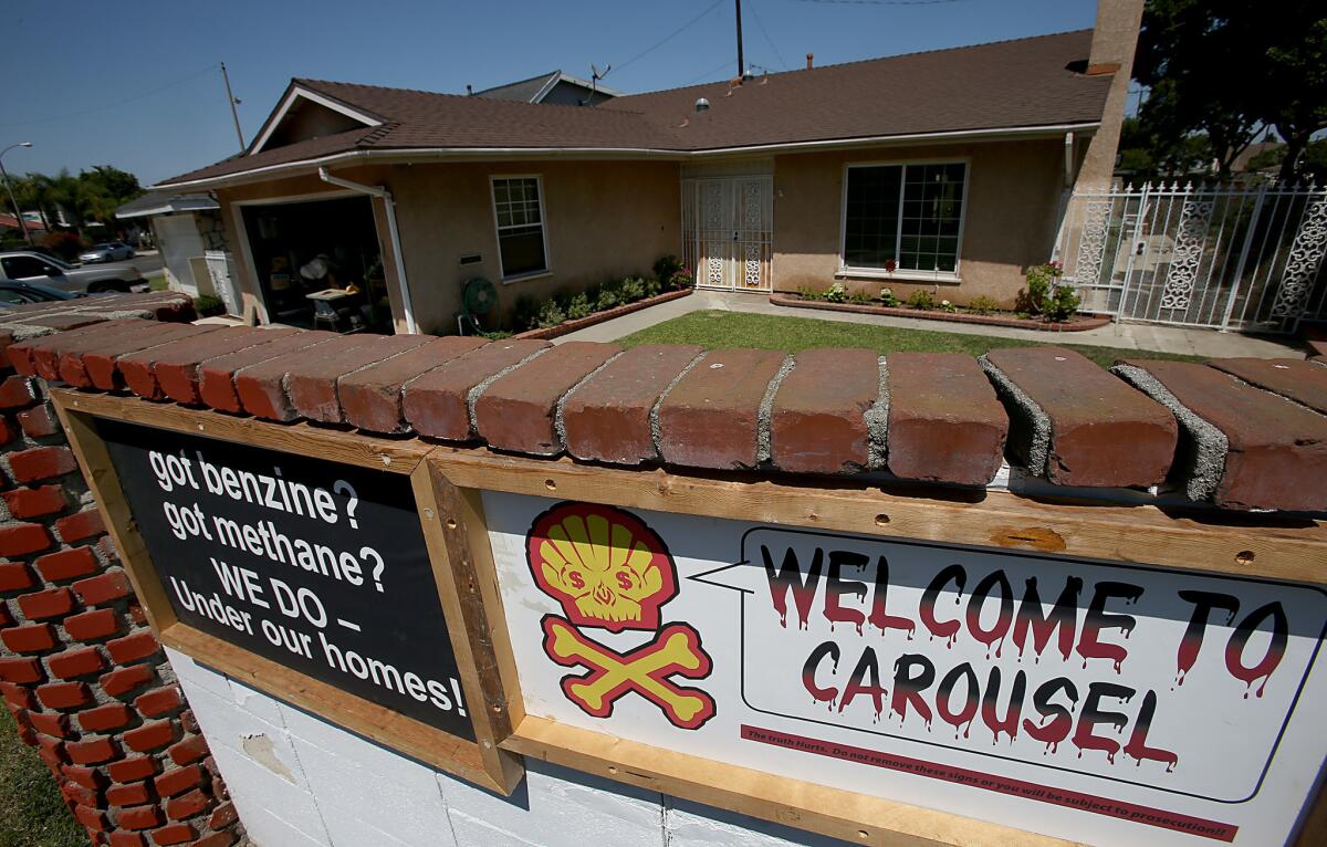 Signs warning of severe ground contamination greet visitors at the entrance to the Carousel neighborhood in Carson.